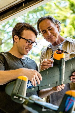 Father and son working together on model of a military plane