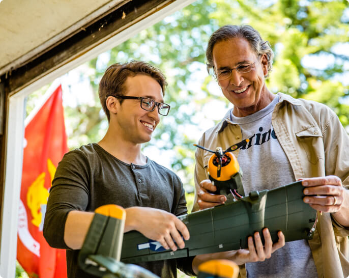 Father and son building model fighter planes together.