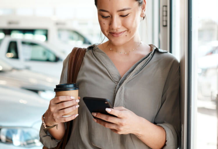 Woman happy using her USAA Classic Checking debit card for online purchases.