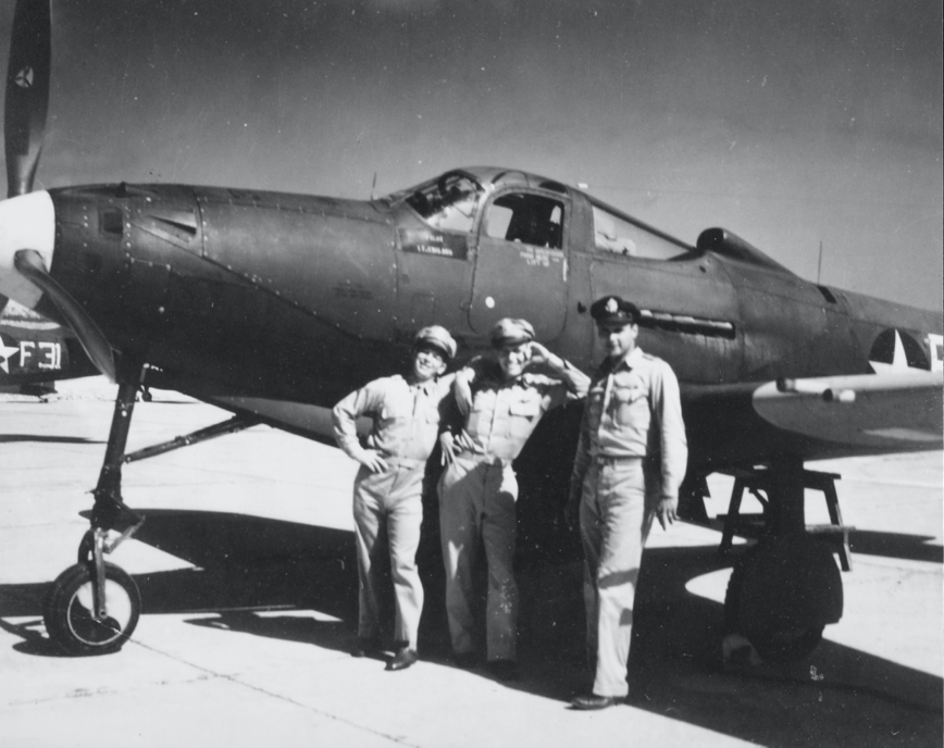 Vintage picture of Military men smiling and standing in front of a plane on the runway.