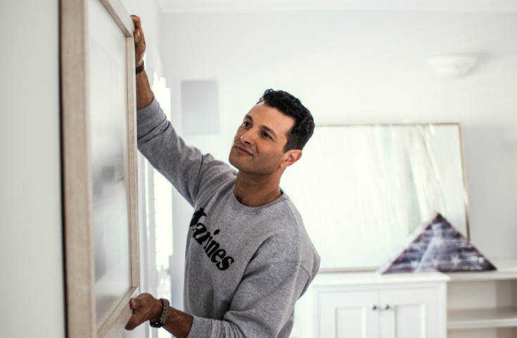 Man hanging a picture