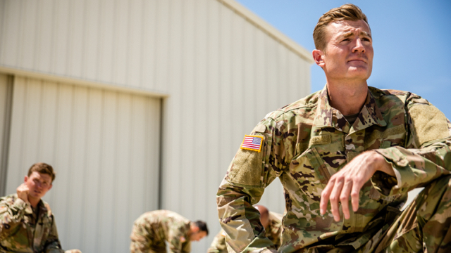 A military member in uniform gets ready for a mission.