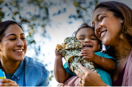 Two women holding baby boy